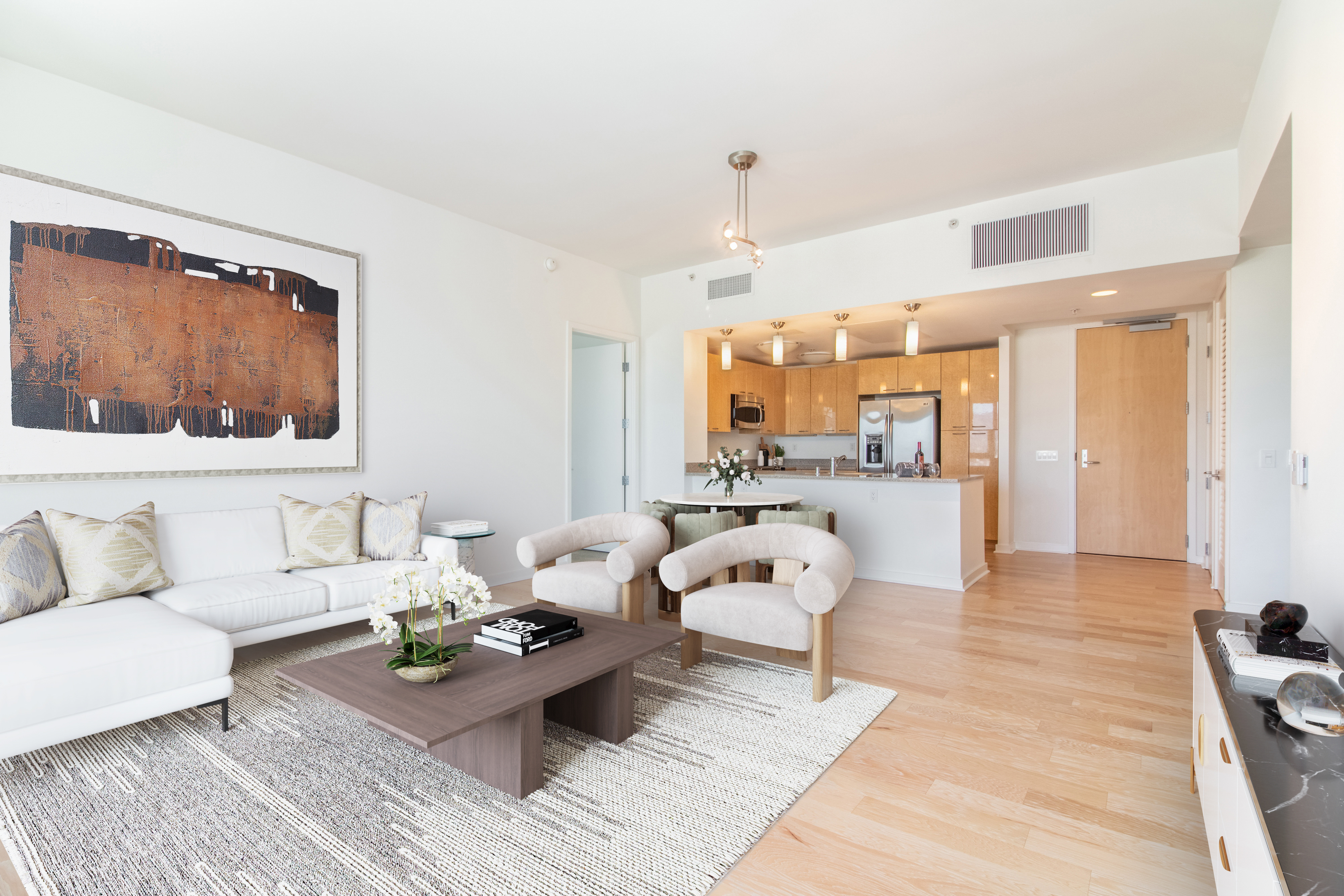 A living room with a white couch and a brown coffee table at The Grand Apartments, Oakland, CA, 94612